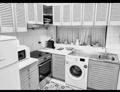 a kitchen with a washing machine and a sink at Albufeira Pescadores Sea view in Albufeira