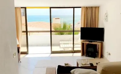 a living room with a view of the ocean at Albufeira Pescadores Sea view in Albufeira