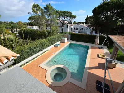 a swimming pool in the middle of a house at Exceptional villa with swimming pool in Almancil