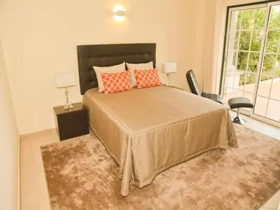 a bedroom with a large bed with orange pillows at Exceptional villa with swimming pool in Almancil