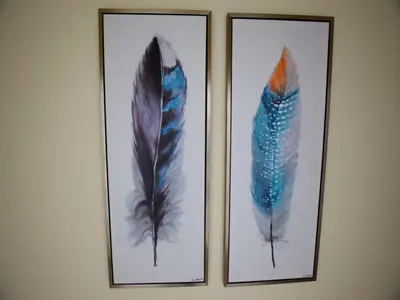 three pictures of feathers in frames on a wall at Exceptional villa with swimming pool in Almancil
