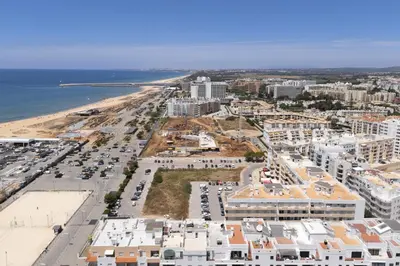 an aerial view of a city and the beach at Golfinho - Sea view with pool by HD in Quarteira