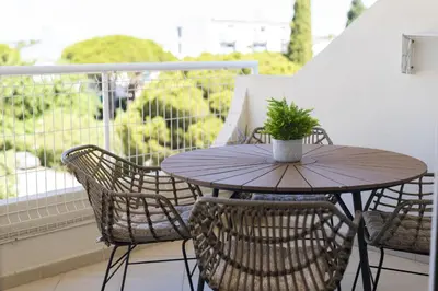 a bedroom with a bed with white walls at Moura One - Condominium with pool by HD in Vilamoura