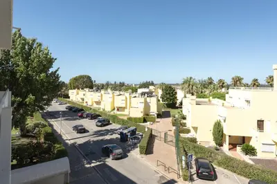 a small room with a bed and a stool at Moura One - Condominium with pool by HD in Vilamoura
