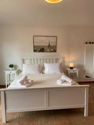 a large white bed with two towels on it at Casas da Corujeira Algarve in Albufeira