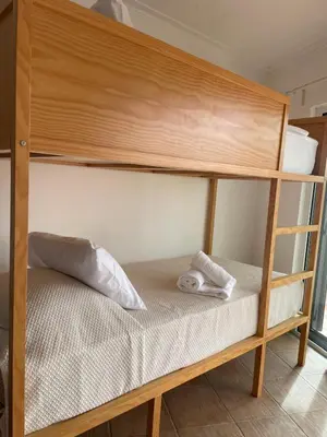 a bunk bed with two towels on the bottom bunk at Casas da Corujeira Algarve in Albufeira