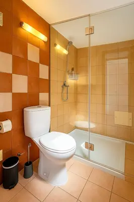 a bathroom with a toilet and a shower and a tub at Casas da Corujeira Algarve in Albufeira