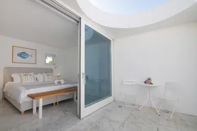 a bedroom with a bed and a sliding glass door at Espuma do Tempo in Quarteira