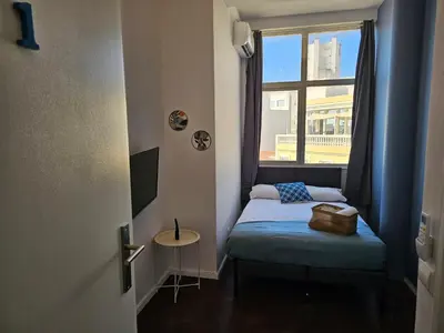 a small room with a bed and a window at Blife Spanya - private rooms at Santantonya 3rd floor in Faro