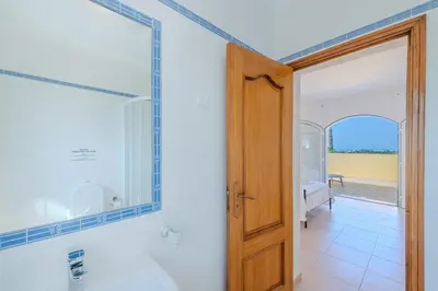 a bathroom with a sink and a mirror at Villa Monte da Torre in Loulé