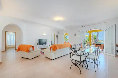 a living room with a couch and a table at Villa Monte da Torre in Loulé