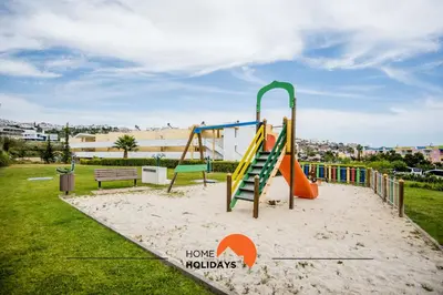 a park with a playground with a slide at #323 Jardins da Marina 2º BE by Home Holidays in Páteo