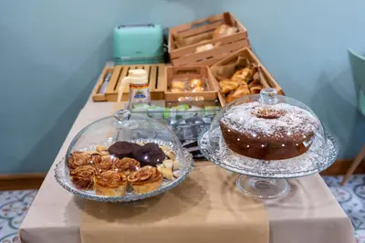 a table with two plates of donuts and a box of pastries at Quinta do Moinho in Loulé
