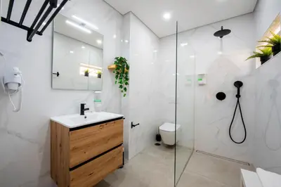 a bathroom with a shower and a sink and a toilet at Quinta do Moinho in Loulé