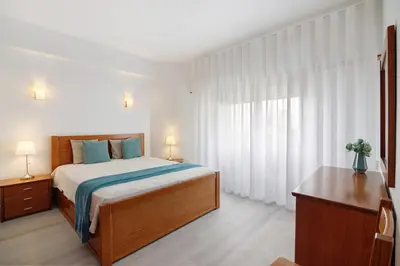 a living room with a couch and a table at Apartamento da Praia in Quarteira
