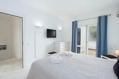 a bedroom with a bed with two towels on it at Serenity Villa Vilamoura in Quarteira