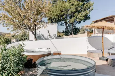 a hot tub on a patio with trees in the background at Casa Majú - Algarve in Valados