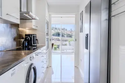 a white kitchen with a washer and dryer at #339 Albufeira Terras Novas N 4 By Home Holidays in Patroves