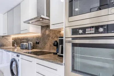 a kitchen with white cabinets and a stove top oven at #339 Albufeira Terras Novas N 4 By Home Holidays in Patroves