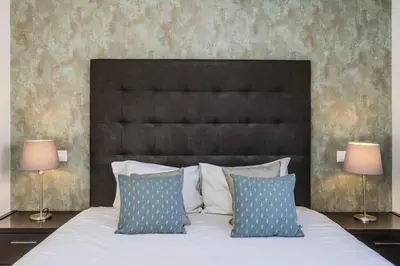 a bedroom with a large bed with two lamps at #339 Albufeira Terras Novas N 4 By Home Holidays in Patroves