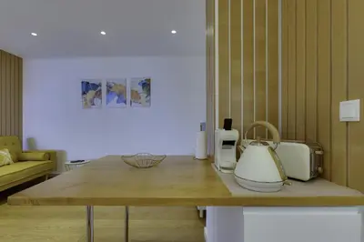 a kitchen with a table with a tea kettle on it at GINGKO BILOBA ROOF TOP by My Algarve Rentals in Quarteira