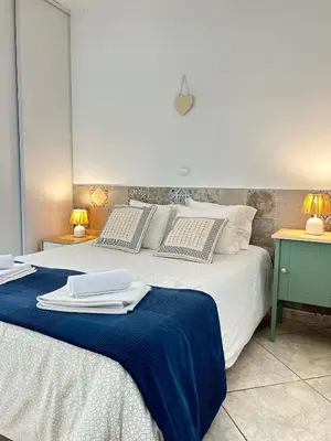 a bedroom with two beds with towels on them at Casa João Bravo in Albufeira