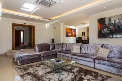a living room with a couch and a table at Luxury Villa with Private Pool, Gym & Leisure Room by Gale Beach LM25 in Guia