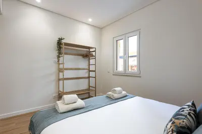 a bedroom with a large bed and a window at Mira Mar 1 - Near the beach by HD in Quarteira