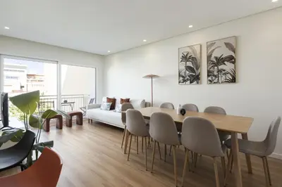 a living room with a table and chairs and a couch at Mira Mar 2 - Near the beach by HD in Quarteira