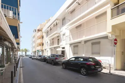 a row of cars parked on a street next to buildings at Mira Mar 2 - Near the beach by HD in Quarteira