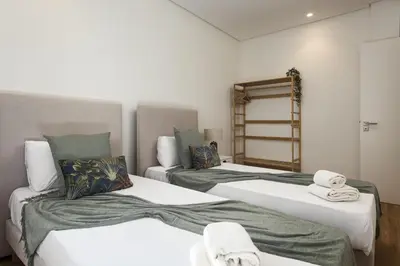 a bedroom with two beds with towels on them at Mira Mar 2 - Near the beach by HD in Quarteira