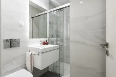a white bathroom with a sink and a shower at Mira Mar 2 - Near the beach by HD in Quarteira