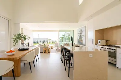 a kitchen and dining room with a table and chairs at New Villa - Rooftop Jacuzzi & Sunset Views in Santa Bárbara de Nexe