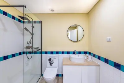 a bathroom with a shower and a toilet and a sink at Exclusive Apartment in Quarteira Walk to Beach in Quarteira