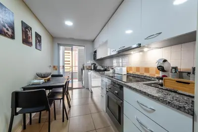 a living room with a table and a couch at Exclusive Apartment in Quarteira Walk to Beach in Quarteira