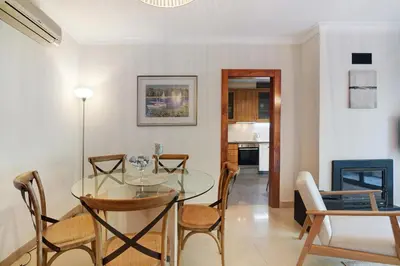 a dining room with a glass table and chairs at Do Vale Hollidays in Guia