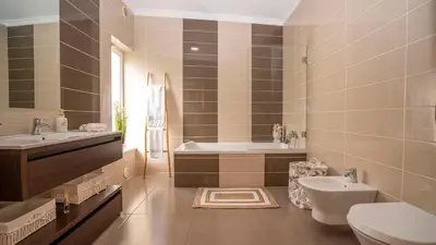 a bedroom with two beds and a large mirror at Homebyvi in Quarteira