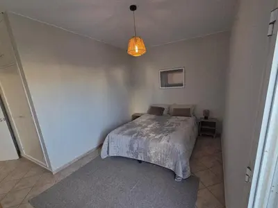 a bedroom with a bed in the corner of a room at Casa Madalena in Albufeira