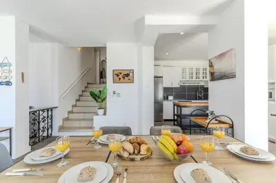 a staircase in a house with a home holidays sign on it at #285 Vista do Mar By Home Holidays in Albufeira