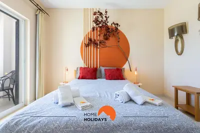 a bedroom with a large bed with red pillows at #121 T1 Aconchegante em Albufeira by Home Holidays in Albufeira