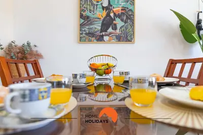 a table with glasses of orange juice on it at #121 T1 Aconchegante em Albufeira by Home Holidays in Albufeira
