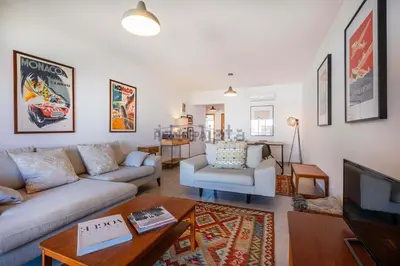 a living room with a couch and a tv at Galé by the Sea in Guia