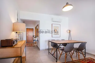 a white table with a chair in a living room at Galé by the Sea in Guia