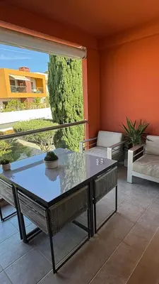 a glass table sitting on a balcony with a couch at Galé by the Sea in Guia
