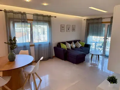 a living room with a couch and a table at Apartamento Flor de Amendoeira Garden in Albufeira