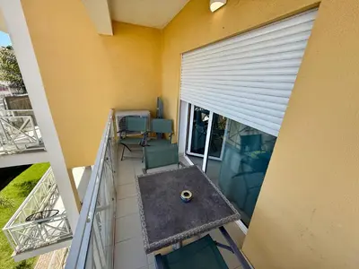 an overhead view of a balcony with chairs and a table at Apartamento Flor de Amendoeira Garden in Albufeira