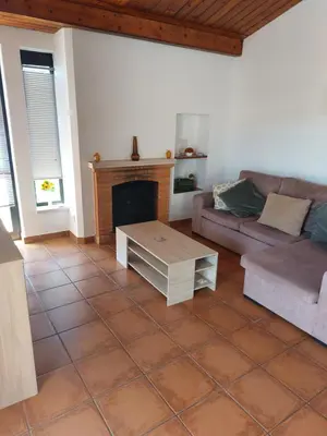a living room with a couch and a fireplace at Jacaranda 43-Moradia terrea in Albufeira