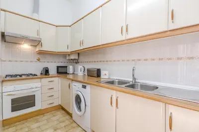 a kitchen with white cabinets and a sink at #341 Casa da Guida 44 by Home Holidays in Olhos de Água