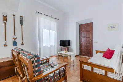 a living room with a bed and a tv at #341 Casa da Guida 44 by Home Holidays in Olhos de Água