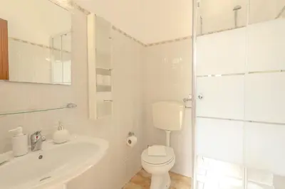 a white bathroom with a toilet and a sink at #341 Casa da Guida 44 by Home Holidays in Olhos de Água